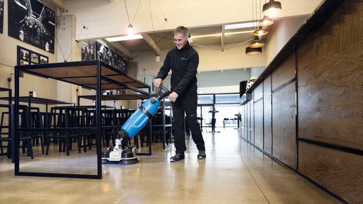 Operator using the Fimap V1 scrubber dryer in a commercial space
